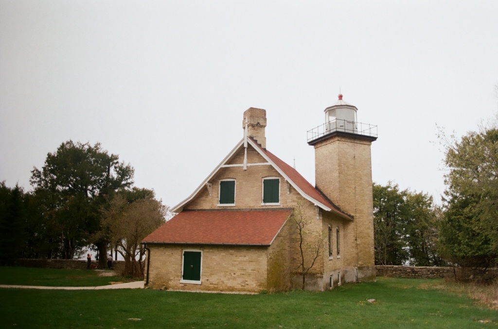 image of the Eagle Bluff lighthouse surrounded by trees taken on colored film